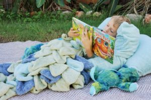 Add some snuggly magic to your life with this whimsical dinosaur blanket sewing pattern. Magic blanket tails for everyone, including the dolls.