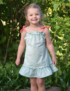 Swing into summer with a stylish silhouette! The children’s Tie Shoulder Tiered Dress is a breezy summer dress that comes in sizes12 months to 12 years.